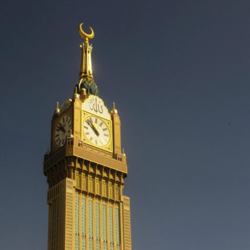 Majestic capture of the Abraj Al Bait Clock Tower in Mekkah against a clear sky.